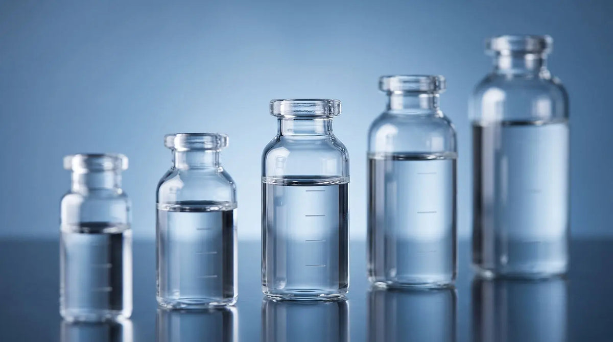 A row of increasingly sized clear solvent vials illustrating reconstitution volume choices.