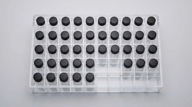 A top-down clear slotted vial box with research vials organized in fixed positions for inventory.